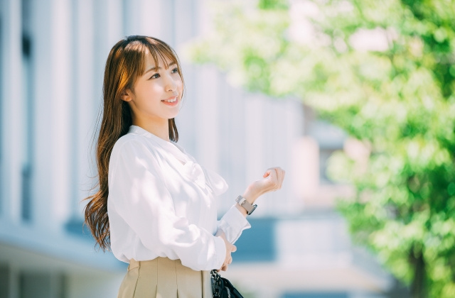 木漏れ日の下にいる長い髪のビジネスウーマン